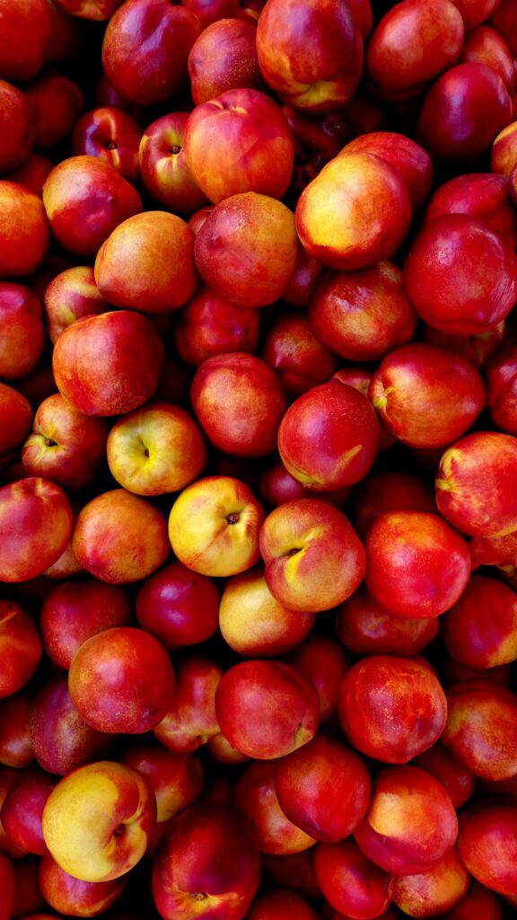 A vibrant display of freshly harvested red nectarines showcasing natural freshness and nutrition.